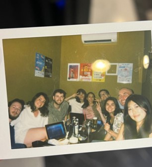 Polaroid picture of people smiling at karaoke bar
