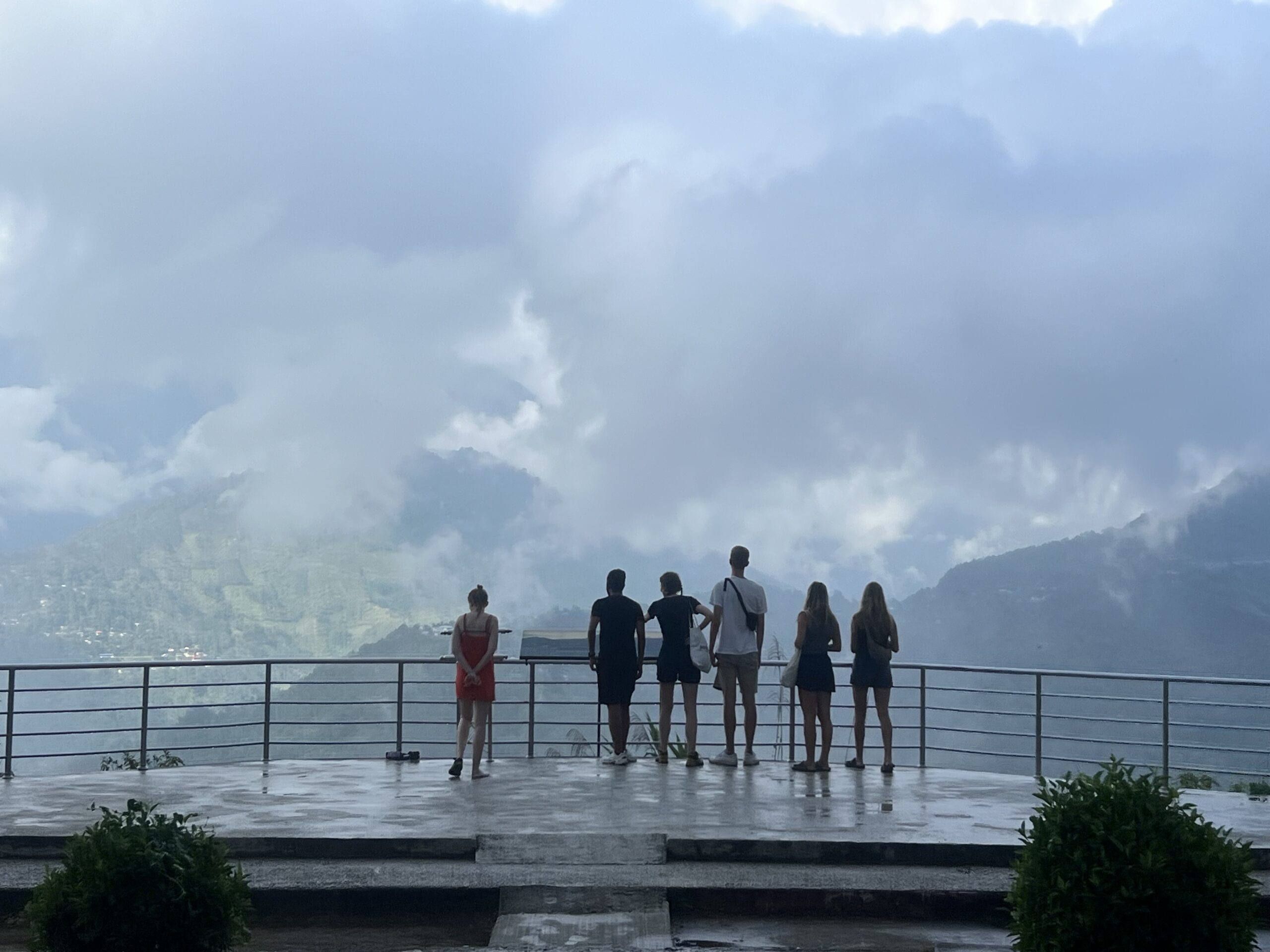 People standing in front of a cloudy view in Malaysia while staying in hostels