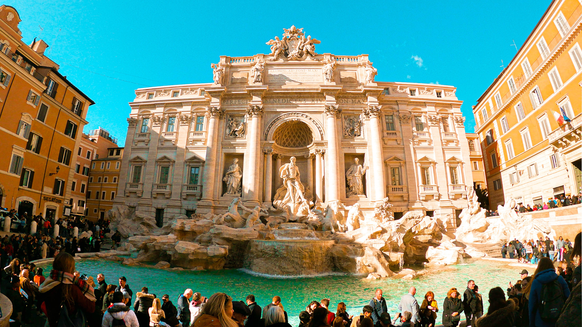 Massive crowd in front of Trevi Fountain sunny afternoon